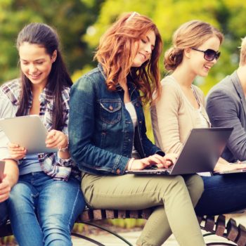 students or teenagers with laptop and tablet computers