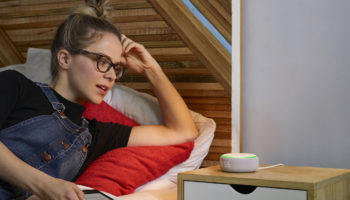 Amazon Echo Dot with Clock on bedside table